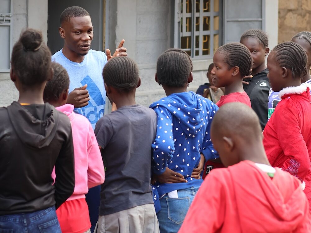 Teddy Omondi speaking with children in Korogocho.
