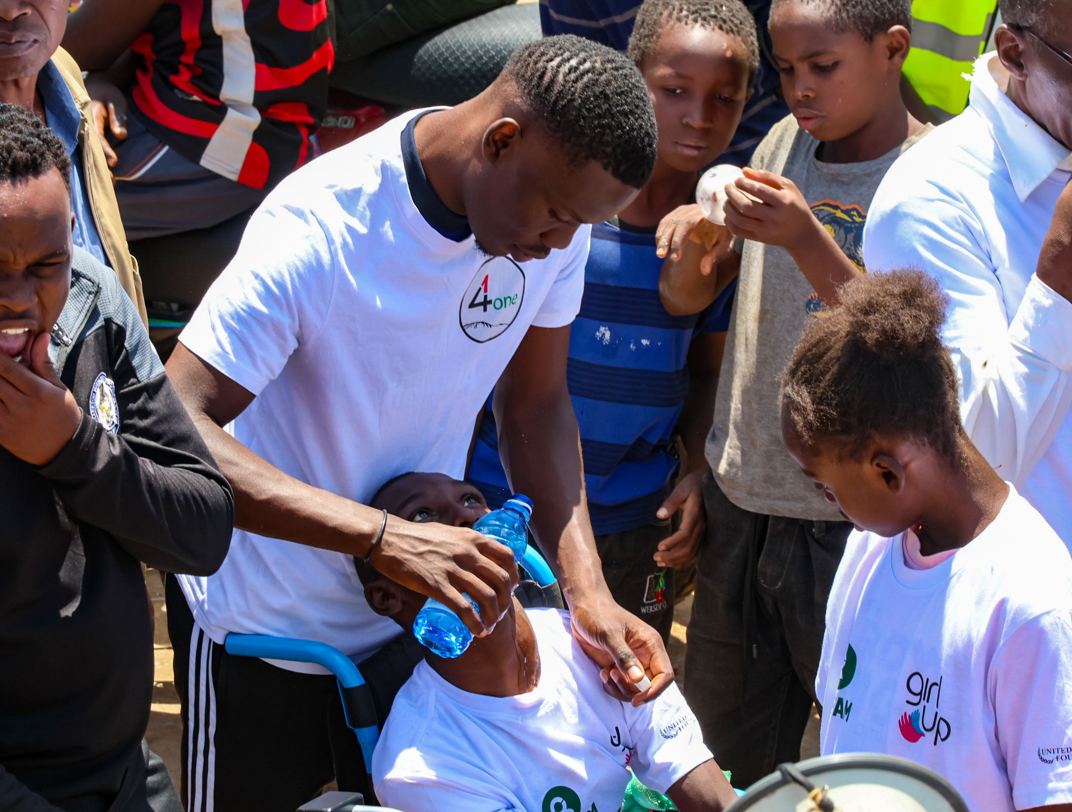 Teddy Omondi Helping special need man with water
